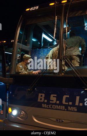 Members of the 45th Infantry Brigade, Oklahoma Army National Guard, board a bus at Camp Shelby, Miss., for the 14-hour ride to Oklahoma City. The 45th has been mobilized in support of Operation Enduring Freedom for a year. More than 2,200 Oklahoma Guardsmen spent about eight months in Afghanistan and another 800 spent the same time in Kuwait. Stock Photo