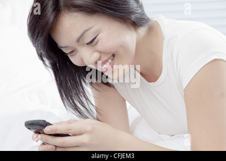 Young woman using cell phone Stock Photo