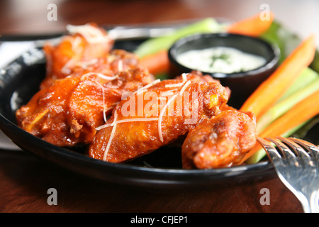 Spicy buffalo wings with bleu cheese dipping sauce Stock Photo