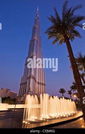 Burj Khalifa and entrance fountains and palm tree at night, Dubai City, United Arab Emirates, Middle East Stock Photo