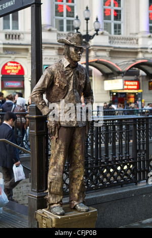 Busker outside Piccadilly Circus Tube Station, London Stock Photo