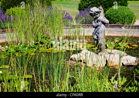 Ornamental pond and statue in the English country garden of Littlecote Manor in Berkshire, England, UK Stock Photo