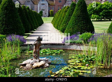 Ornamental pond,statue and topiary in the English country garden of Littlecote Manor in Berkshire, England, UK Stock Photo