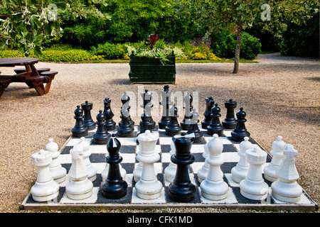 An large outdoor chess set in the English country garden of Littlecote Manor in Berkshire, England, UK Stock Photo