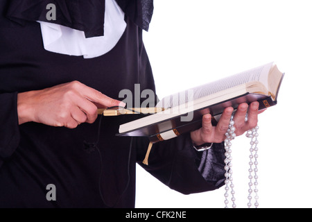 Close up of a nuns hand holding a bible and a cross Stock Photo