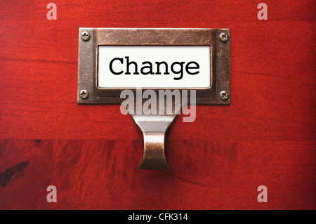Lustrous Wooden Cabinet with Change File Label in Dramatic LIght. Stock Photo