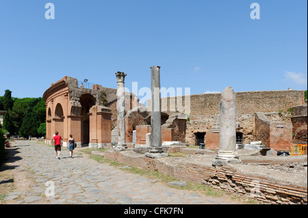 Ostia Antica. Lazio. Italy. View along the basalt stone paved Decumanus Maximus towards the Roman theatre built by Agrippa in Stock Photo