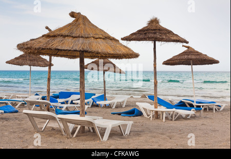 Parasols on beach after a barrage of wind Stock Photo