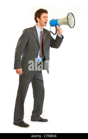 Full length portrait of frustrated modern businessman yelling through megaphone isolated on white Stock Photo