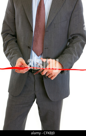 Closeup on businessman cutting red ribbon isolated on white Stock Photo