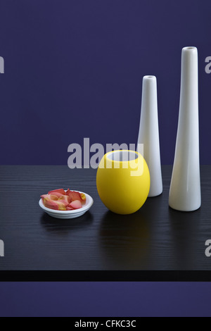 Vases on black Shelf against blue painted Wall Stock Photo