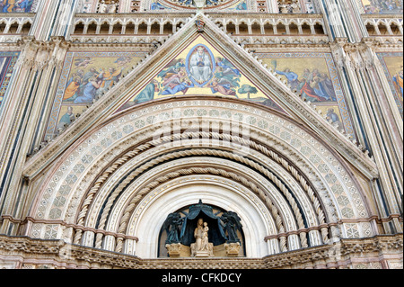 Orvieto. Umbria. Italy. Close-up view of central section of the stunning and grandiose marble and mosaic Gothic facade of