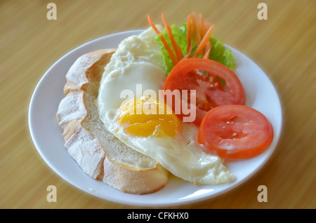 american style breakfast , with toast, fried egg and fresh vegetables Stock Photo