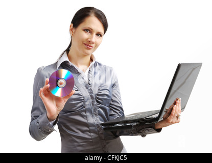 Pretty office worker holding a laptop and DVD disk. Stock Photo