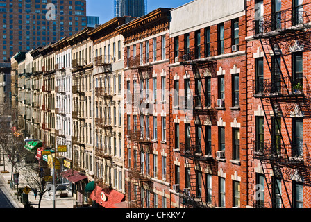 Fire escapes on tenement apartment buildings in Harlem neighborhood, New York City. Stock Photo