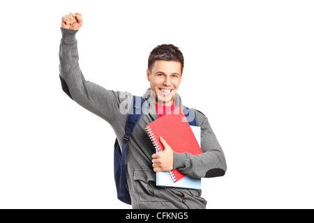 A happy student holding books and gesturing isolated on white background Stock Photo