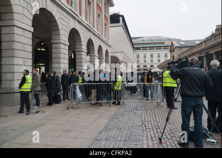 Customers queuing outside the apple store as Apple iPad 3 go on sale at the Apple store, Covent Garden, London. Stock Photo