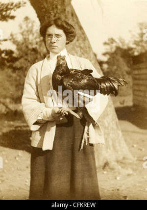 Middle Aged Woman Holding Chicken Stock Photo