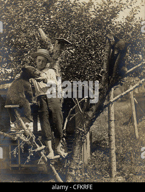 Barefoot Boy Feeding a Tame Baby Bear Stock Photo