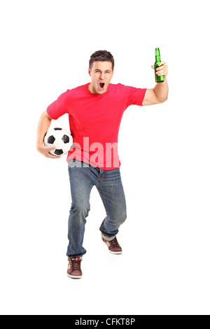 Full length portrait an euphoric fan holding a beer bottle and football cheering isolated on white background Stock Photo