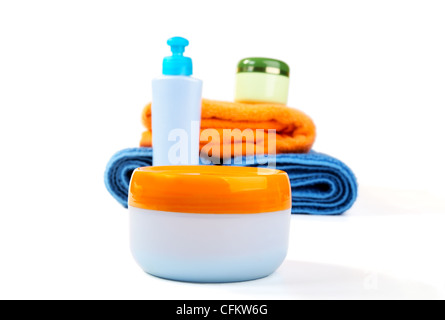 Terry towels and tubes with cosmetics isolated on a white background Stock Photo