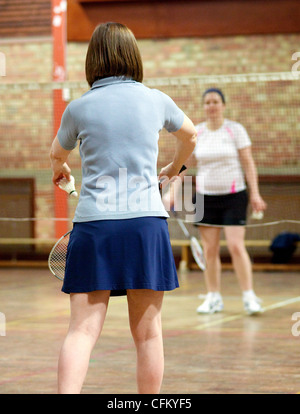 Two women playing badminton at their local club, Newmarket Suffolk UK Stock Photo