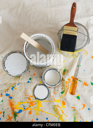 USA, New Jersey, Jersey City, Paint cans and paintbrushes on drop cloth Stock Photo