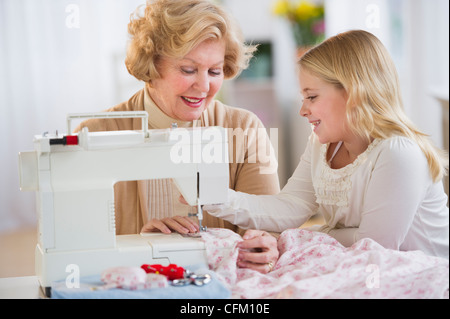 USA, New Jersey, Jersey City, Grandmother with granddaughter (8-9) sewing together Stock Photo