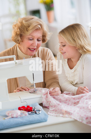 USA, New Jersey, Jersey City, Grandmother with granddaughter (8-9) sewing together Stock Photo