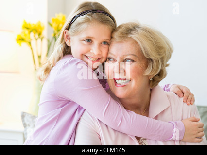 USA, New Jersey, Jersey City, Granddaughter (8-9) hugging grandmother Stock Photo