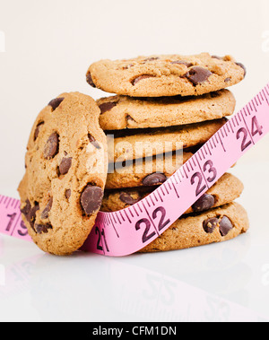 Stack of chocolate chip cookies with measure tape Stock Photo