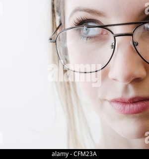 Portrait of young woman wearing glasses, studio shot Stock Photo