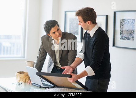 USA, New Jersey, Jersey City, Two men working in art gallery Stock Photo