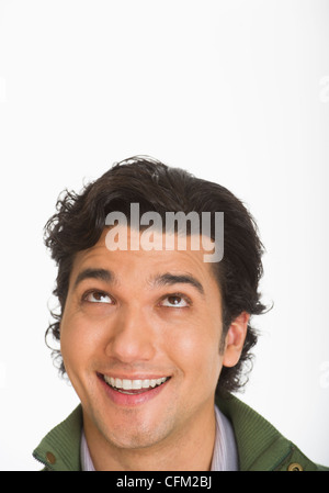 Studio shot of young man looking up Stock Photo