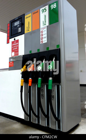 Four gas pump nozzles on a petrol station Stock Photo