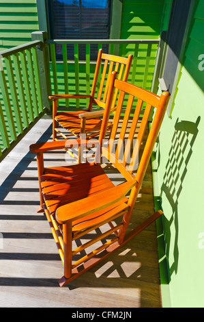 Two empty wood rocking chairs on green balcony at Mohonk Mountain House, at New Paltz, upstate New York, USA, 2012 Stock Photo