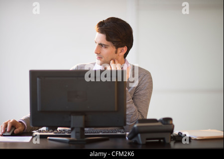 USA, New Jersey, Jersey City, Business man working on computer Stock Photo