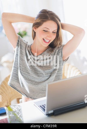 USA, New Jersey, Jersey City, Portrait of young woman working with laptop Stock Photo