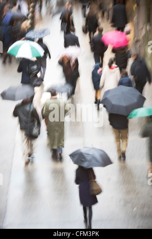 Pedestrians with umbrella Stock Photo - Alamy