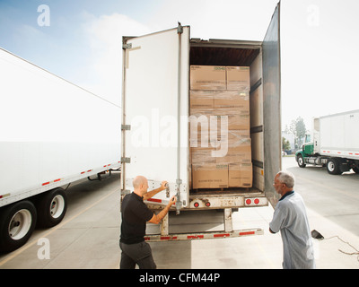 USA, California, Santa Ana, Two men close in truck trailer Stock Photo