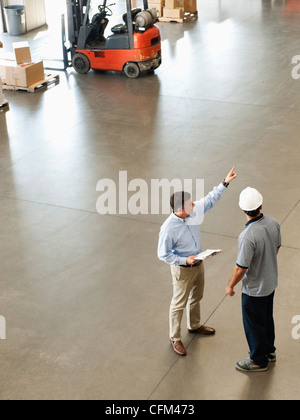 USA, California, Santa Ana, Workers talking in warehouse Stock Photo
