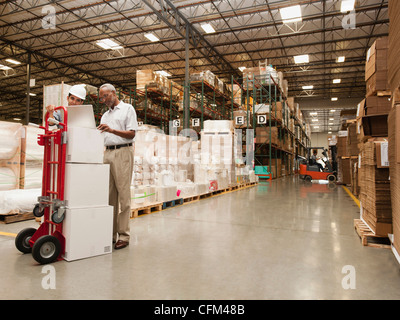 USA, California, Santa Ana, Men working in warehouse Stock Photo