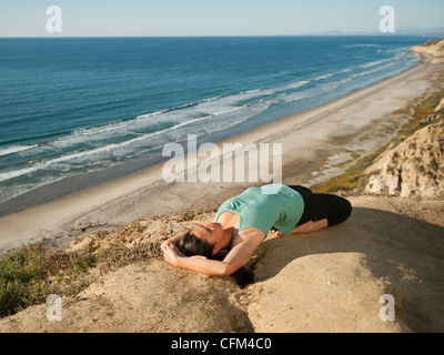 USA, California, San Diego, Woman practicing yoga on beach Stock Photo