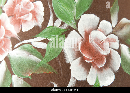 flower and green leaf print on brown fabric Stock Photo