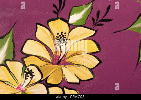 yellow flower and green leaf print on purple leather Stock Photo