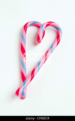 Candy canes in heart shape, studio shot Stock Photo