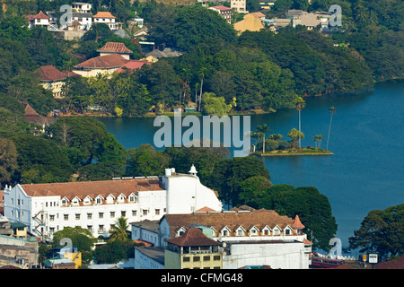 The old-fashioned white Queen's Hotel by the famous lake in the old Sinhalese hill country capital, Kandy, Sri Lanka, Asia Stock Photo