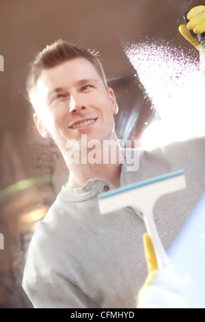 USA, Arizona, Phoenix, Man cleaning window pane Stock Photo