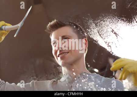 USA, Arizona, Phoenix, Man cleaning window pane Stock Photo
