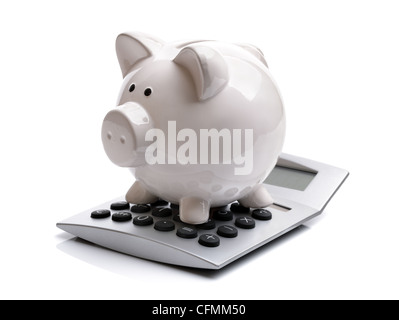 Piggy bank and calculator isolated on white background Stock Photo - Alamy